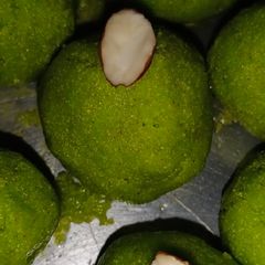 A picture of Sooji ladoo in green color.