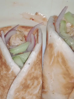 A picture of Toasted shawarma with veggies.