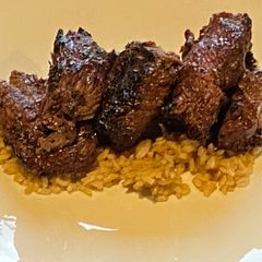 A picture of Bourbon Marinated Tenderloin over Brown Rice.