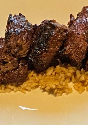 A picture of Bourbon Marinated Tenderloin over Brown Rice.