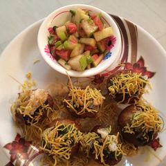 A picture of Aloo Puri with cut fruits.