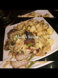 A picture of Baked potatoes and oven fish with cabbage sauce.