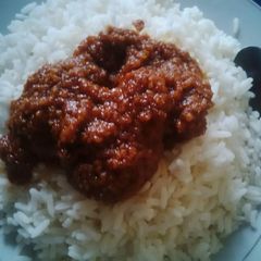 A picture of Boiled rice with carrots stew.