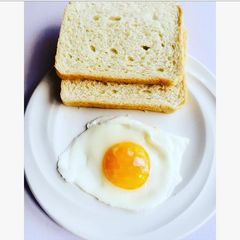 A picture of Pouch egg served with bread.