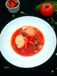 A picture of Beetroot Carrot Soup with Caraway Dumplings.