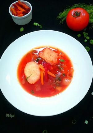 A picture of Beetroot Carrot Soup with Caraway Dumplings.
