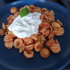 Orecchiette with tomato and burrata cheese A picture of Orecchiette with tomato and burrata cheese.