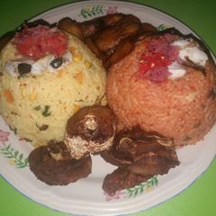 Fried rice and jollof with fried plantain and fried chicken A picture of Fried rice and jollof with fried plantain and fried chicken.