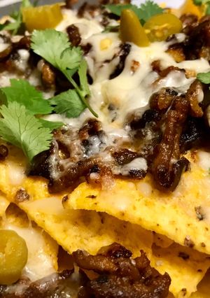 A picture of Nachos with Meat, Cheese, and Poblano Peppers.