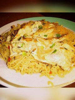 A picture of Noodles with fried egg.