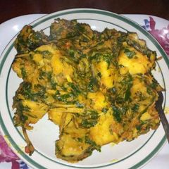 A picture of Yam porriage with ugba and vegetable.