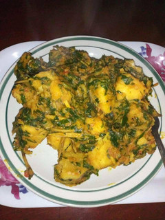 A picture of Yam porriage with ugba and vegetable.