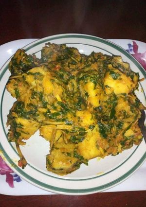 A picture of Yam porriage with ugba and vegetable.