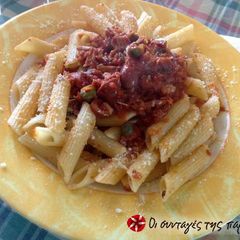 A picture of Penne with tuna and tomato.