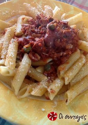 A picture of Penne with tuna and tomato.