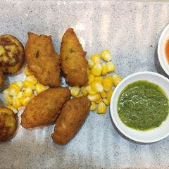 A picture of Corn pakodas (fritters) and appe.