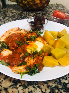 A picture of Eggs in tomato sauce.