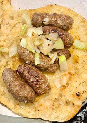 A picture of Ćevapčići/Ćevapi (Mini Bosnian Kebabs).