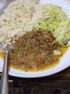 A picture of Rice with ndengu and steamed cabbage.