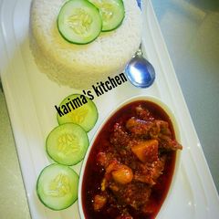 A picture of Rice and palm oil stew.
