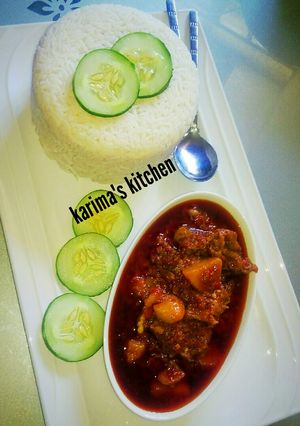 A picture of Rice and palm oil stew.