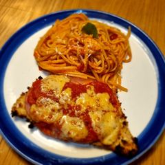 A picture of Oven-baked Chicken Parmigiana with 🍅 pasta.