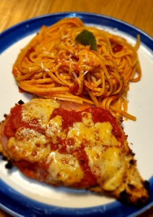 A picture of Oven-baked Chicken Parmigiana with 🍅 pasta.