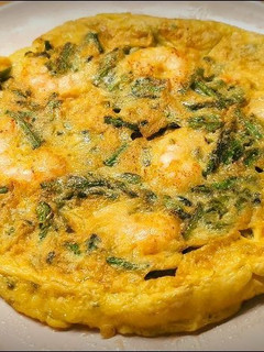 Una foto de Tortilla de trigueros con gambas rojas