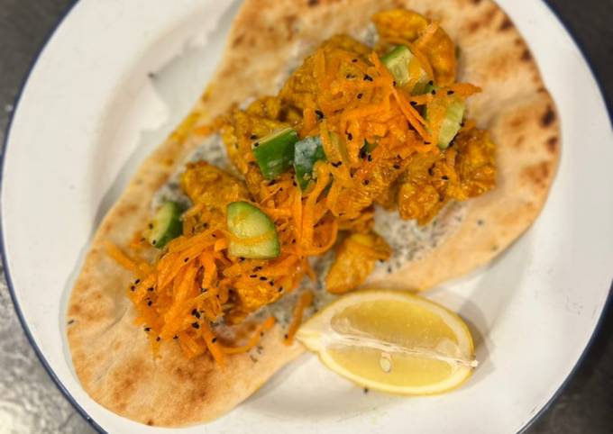 Chicken tikka on naan with fragrant salad