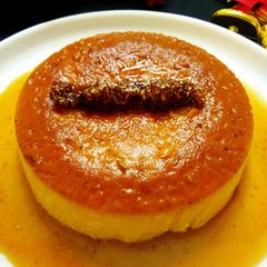 A picture of Christmas special eggless caramel custard pudding cake with dry fruit chikki log.
