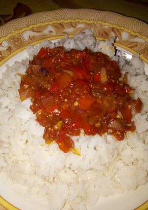 A picture of White rice and tomatoes sauce.