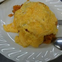 A picture of Omlet containing fried rice.