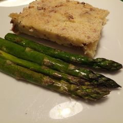 A picture of Potato pie, with pancetta & chanterelle mushrooms & asparagus.