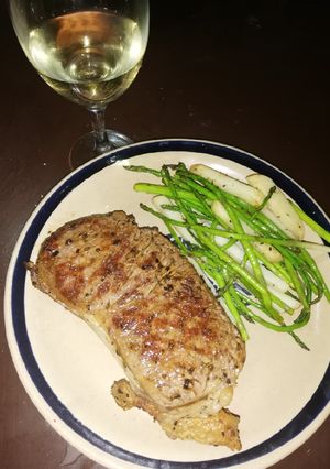 Una foto de Corte Rib eye y espárragos con papa de guarnición