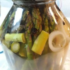 A picture of Pickled Asparagus with an Onion.