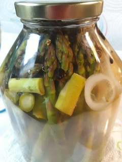 A picture of Pickled Asparagus with an Onion.