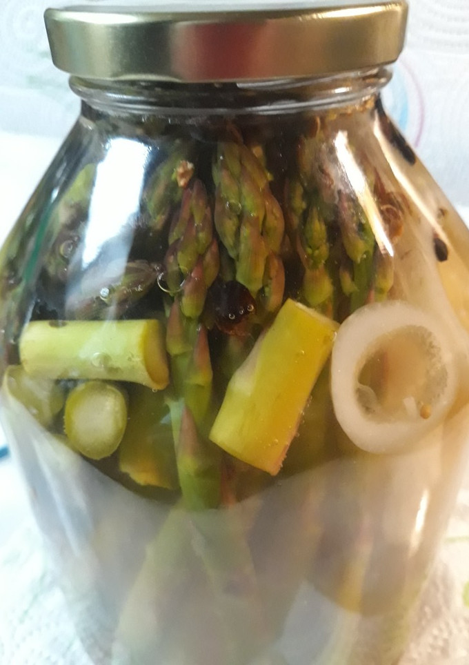A picture of Pickled Asparagus with an Onion.