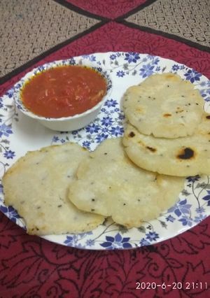 A picture of Rice flour paratha with tomato chutney.