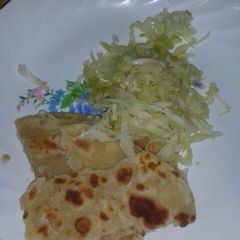 A picture of Steamed cabbage served with chapati.