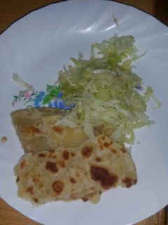 A picture of Steamed cabbage served with chapati.