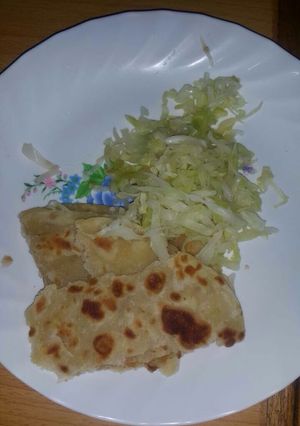 A picture of Steamed cabbage served with chapati.