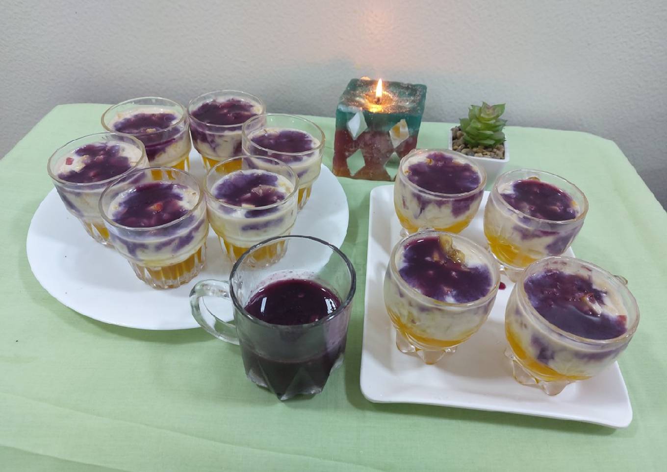 Fruits creamy with pineapple jelly and black currant sauce