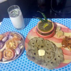 A picture of Sarson ka saag with bajre ki roti.