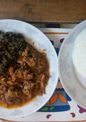 A picture of Dry fry meat and ugali with managu/mchicha.