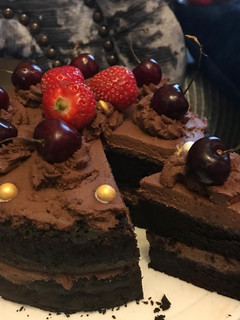 A picture of Chocolate cake with chocolate fresh cream.