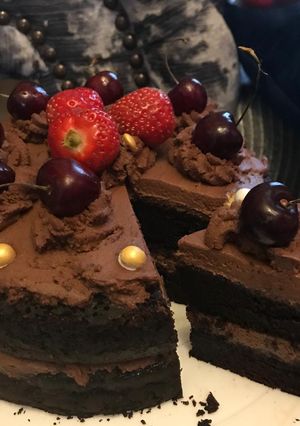A picture of Chocolate cake with chocolate fresh cream.