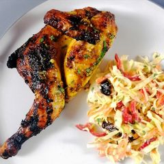 A picture of Spatchcock poussin glazed with orange and honey and festive slaw.