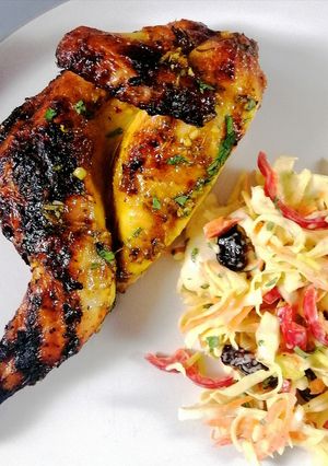 A picture of Spatchcock poussin glazed with orange and honey and festive slaw.