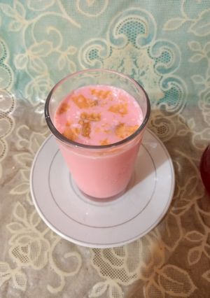 A picture of Rose milk with biscuits 🥤🥤🫓🫓.