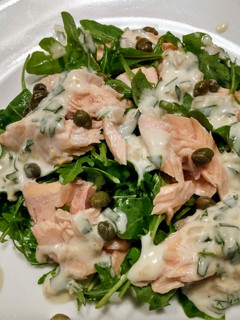 A picture of Poached salmon and arugula with creamy tarragon dressing.